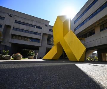 A large yellow sculpture outside Posvar Hall
