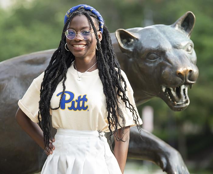 Danielle Obisie-Orlu posing in front of panther statue