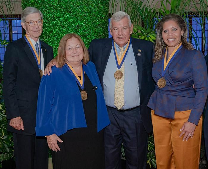 four awardees wearing medals