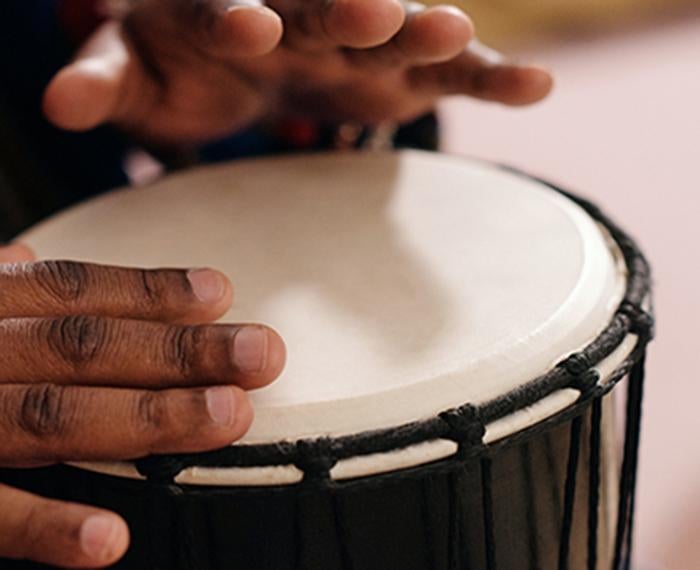 Hands on a djembe drum