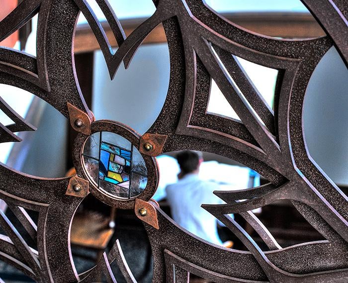 A stained glass window in decorative iron