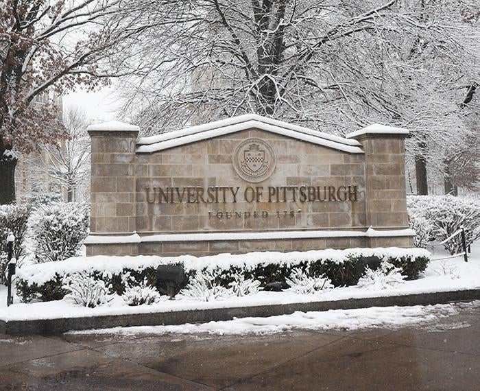 The University of Pittsburgh sign on a snowy day