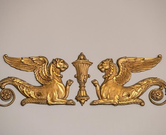 Golden wall ornaments depict two winged lions
