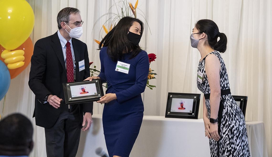 Jacqueline Burgette and Peggy Liu receiving their award 